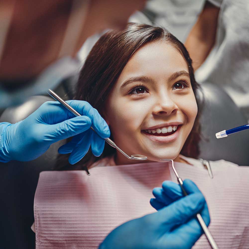 kid in dental chair smiling